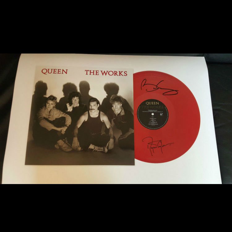 Roger Taylor, Brian May of Queen sign and sell limited edition LPs