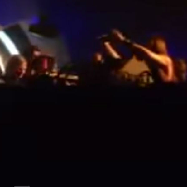 Richie Hawtin pushes monitor onto fan filming his set