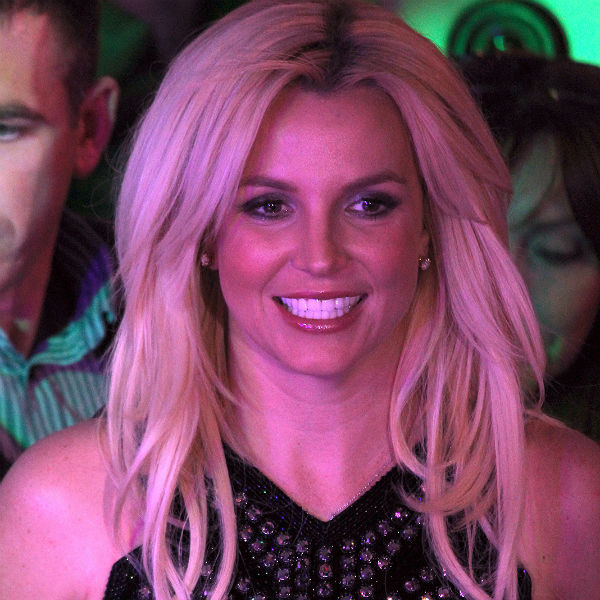 Britney Spears falls and sprains ankle on stage, reschedules shows