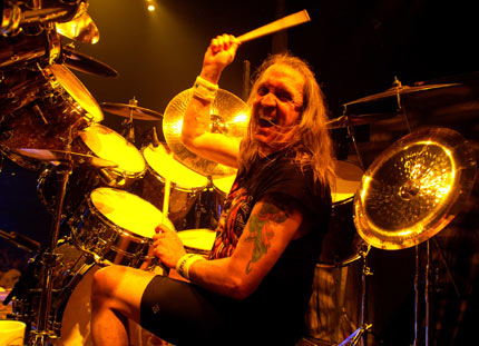 Nicko McBrain of Iron Maiden %u2013 Hailed by a drummer magazine as a %u201Clived-in legend%u201D, this may be one of the understatements of the century where Iron Maiden are concerned, but calling him one of rock%u2019s greatest drummers certainly isn%u2019t. Steve Harris said McBrain %u2018drives the whole thing along,%u2019 perfectly summating his skill- ably coping with even the most complex of IM%u2019s glut of time signatures.